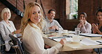 a young businesswoman having a meeting with her colleagues in a modern office. A smiling young businesswoman in a meeting with her coworkers clapping and celebrating her success.