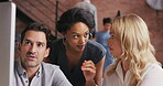 a group of businesspeople using a computer in a modern office. Powerful young businesswoman collaborating with colleagues working on a computer. Serious businesspeople talking in a meeting