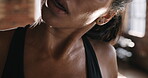 Strong young athlete wiping sweat from herself and taking a break during her cardio workout. Powerful fit woman ready for her boxing exercise at the gym. Boxer taking a break from her workout