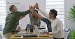 Group of diverse businesspeople giving each other high five during meeting in an office boardroom. Colleagues staying motivated and inspired. Staff celebrating success and achievement as a united team