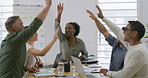 Group of five diverse businesspeople giving each other a high five a meeting in an office at work. Colleagues joining their hands in support and motivation. Business professionals planning together