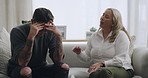 Man crying and being comforted by psychologist during therapy. Upset and anxious man with his head in his hands and sharing trauma story with mature therapist. Stressed and seeking mental health help