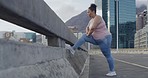 One mixed race plus size woman starting a weight loss journey and focusing on health, cardio, fitness and energy. Hispanic woman getting fit and stretching before her workout in the city