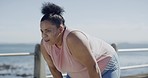 One plus size woman starting a weight loss journey and focusing on health, cardio, fitness and energy. Hispanic woman catching her breath and checking her smartwatch to track her goals