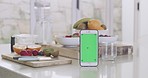 Closeup of a cellphone with a green chromakey on the screen and fresh fruit in the background. Using technology to advertise, promote and market nutritional and organic produce online. Eating healthy