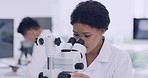 Portrait of a female scientist using a microscope in a laboratory. A healthcare professional analyzing samples for researching a vaccine cure in a scientific health facility, a passion for biology