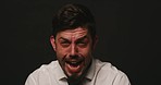 Face portrait of schizophrenia patient against black studio copy space background. Insane, angry, crazy, mentally ill man screaming, crying, fuming. Suffering from dissociative personality disorder