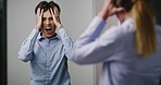 Portrait of a screaming, annoyed, bipolar woman looking in a mirror. Asylum patient suffering from mental health, stress and mood disorder. Businesswoman feeling insane, angry, crazy and tugging hair