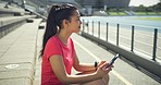 Fit, active, sporty, athletic woman updating health report goal on fitness app. Thinking athlete texting on phone, feeling successful, proud after finished workout training exercise in sports stadium