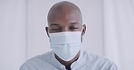 Closeup portrait of an African American wearing a face mask to protect himself against the corona virus pandemic with copyspace. Black man doing his part to stop the spread of disease and sickness