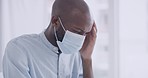 Black man wearing a mask while sitting in a hospital waiting for appointment or checkup. Patient with corona virus or monkeypox symptoms. Feeling his throat or lymph nodes while suffering with pain