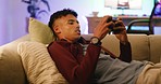 A frustrated gamer with a phone, losing on an online video game. A young trendy guy playing multiplayer on an interactive gaming app, failing, sighing and giving up at a challenging level or stage
