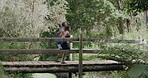 Fit couple running on a forest bridge and on a dirt road path. Active, athletic boyfriend and girlfriend bonding, training, exercising and jogging in social woods run. Man and woman in nature workout