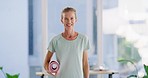 Active mature woman holding a yoga mat in a fitness studio or at home. Portrait of a confident smiling caucasian lady feeling cheerful, content and excited to enjoy a relaxing training session