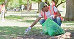 Male volunteer cleaning a park in his community. Responsible council workers, activists and volunteers collecting garbage and litter to reduce pollution for a sustainable, clean and safe environment
