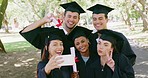 Group of graduates using phone for social media selfies after graduation ceremony on university campus. Diverse men, women or friends using technology and holding degree after graduating from college