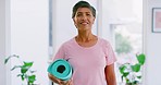 Portrait of a mature woman holding a exercise mat and ready to start exercising. Senior female doing yoga to stay fit and active during retirement. Smiling lady taking good care of her health