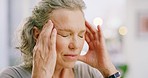 Senior woman with headaches rubbing her forehead in pain. Face of a stressed, tired and anxious lady unable to concentrate while feeling sick from chronic migraines. Worried female in mental distress