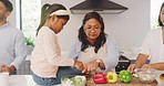 Family cooking in the kitchen together. Siblings helping their mother prepare a wholesome nutritious recipe meal in their modern home. Parent teaching her daughter how to cook healthy vegetable foods