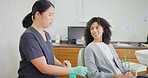 A female dentist consulting a patient visiting for a checkup. A young woman talking to a professional for her oral care. A lady getting medical advice about her teeth and gums from a dental surgeon