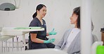 Dentist and patient consulting and discussing in an office. Two women talking about the best treatment for cavity prevention, teeth, oral or hygienic care after having a clean and polish procedure