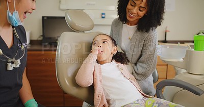Dentist examining little girls mouth during dental appointment. Brace ...