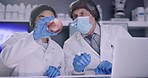 Two scientists experimenting and testing blood samples in medical research laboratory. Pathologists recording findings and results online. Researchers analyzing biochemicals and developing cure