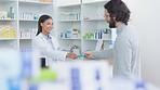 Patient buying medicine from pharmacist at the pharmacy store. Customer receives prescription medication at the chemist store from medical doctor. Healthcare professional accepts credit card payment