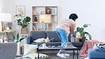 Time lapse of a woman spring cleaning her home. Young female doing routine chores while tidying the lounge to keep her apartment neat and organized. Busy with housework for a hygienic living space