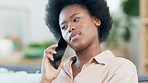 Face of a young happy woman taling to a friend on a phone call while relaxing at home alone. Cheerful and carefree black female with an afro having a conversation and catching up with a loved one