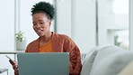 Young woman talking on a call on a phone and browsing the internet while relaxing on the couch alone at home. One happy female entrepreneur having a conversation with a friend and searching the web