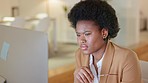 Annoyed business woman reading a negative email in a modern office. Frustrated team leader checking her teams work at night, angry about mistakes at work. Professional lady angry about slow internet