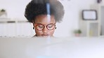 Happy African American business woman responding to an email in a modern office. Young black female smiling while using the internet to plan and manage her busy schedule. Lady researching a startup