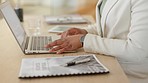 A female lawyer working on a case for a client in her office. Closeup of a business woman typing a financial proposal at her workplace. Entrepreneur using a laptop to compile an insurance document