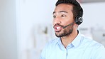 Closeup of the face of a young call center agent talking to 
a client and answering questions online. Male customer service representative giving advice to people and helping them with IT support