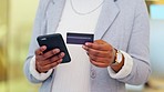 Woman making an online payment on her phone with a credit. Closeup of a person doing online shopping or applying for a loan via banking app. Female paying off insurance debt and debit orders