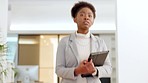 Confident African Executive walking to the boardroom at the workplace. Female Director or company leader struts in an office corridor determined to lead the business. Corporate woman with confidence