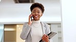 Female manager talking on a phone call and holding a digital tablet, walking to a meeting or appointment in a modern office. Stylish african and young business woman chatting to colleagues inside