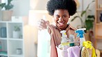 Woman laughing, having fun and spring cleaning at home. Portrait of a female sanitizing the camera while doing routine chores to keep things neat and tidy. Busy with housework for a hygienic house