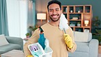 Portrait of a man getting ready to clean his house alone. One young, happy and cheerful Asian male cleaner preparing to do housework and chores with household cleaning products in the living room