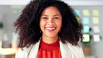 Portrait of a black business woman smiling and laughing while working in an office. One confident manager and cheerful african entrepreneur with curly hair feeling motivated and ambitious for success