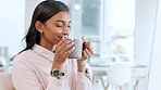 Young business woman smelling the aroma of a fresh cup of coffee during a break in the office. Happy corporate professional taking a deep breath to enjoy the scent of her drink while resting at work