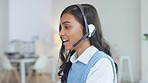 Friendly call center agent using a headset while consulting for customer service and sales support. Confident and happy young business woman smiling while operating a helpdesk and talking to clients