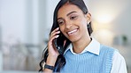 Young business woman talking on a phone call in an office. Confident designer smiling while communicating in a successful startup. Getting good news while networking and making deals with clients