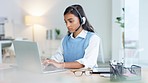 Portrait of a young female call center agent talking to clients and answering questions online while using a laptop. Customer care representative giving advice and assisting people with IT support