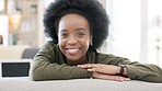 Face of a happy afro woman relaxing indoors on the weekend. Beautiful, cheerful and carefree African American girl having a stressless day at home relaxing in her modern bright living room apartment