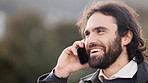 Happy man talking on a phone call alone outside with copy space. Friendly male chatting to friends on a cold morning. Casual young guy with messy hair being social and using wireless device