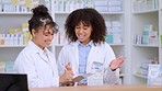 Two female pharmacists use a checklist and discuss work in a pharmacy. Professional young chemists talk about prescription or chronic medication, taking notes, and working in a clinic or dispensary
