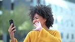 Young female afro student waving at her phone while making a video call out in city. Cool, funky and fashionable woman greeting, smiling and talking while chatting online using wireless technology