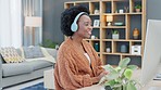 Call center agent talking and helping customers while wearing a headset and working on a desktop computer at home. Happy and cheerful black woman working in sales and networking with clients online